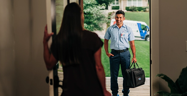 Aire Serv technician standing in front of a customer.