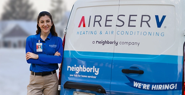 Aire Serv technician standing near the brand van.