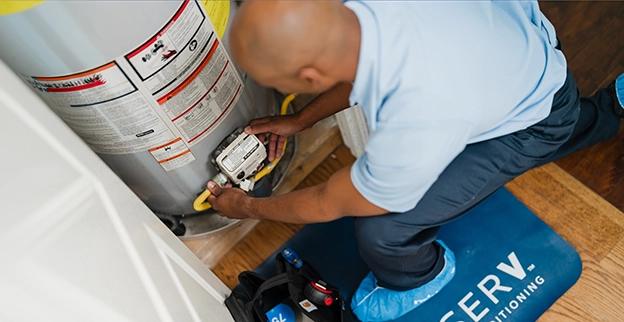 ASV technician working on the water heater.