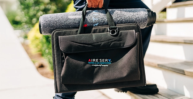 Aire serv technician arriving with the tool bag.