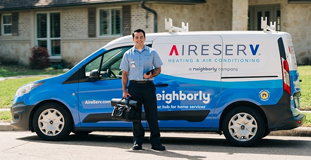 Aire Serv technician standing in front of an Aire Serv van.