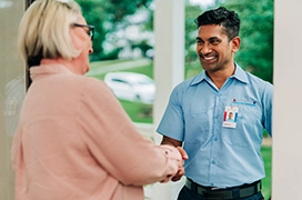 Aire Serv tech shaking hands with customer.