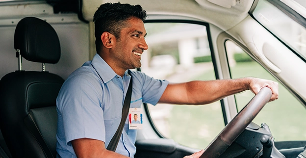 Aire Serv technician behind the wheel of an Aire Serv van.