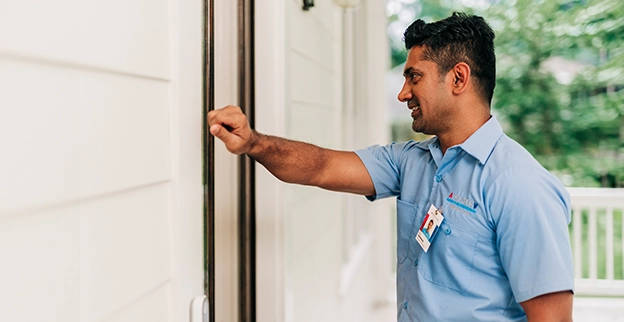 Aire Serv technician knocking on a customer's door.