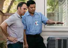 Aire Serv technician discussing HVAC unit maintenance with a homeowner outdoors.