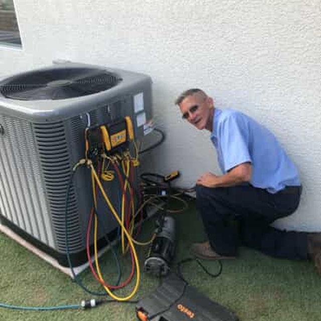 AirServe technician working on AC unit