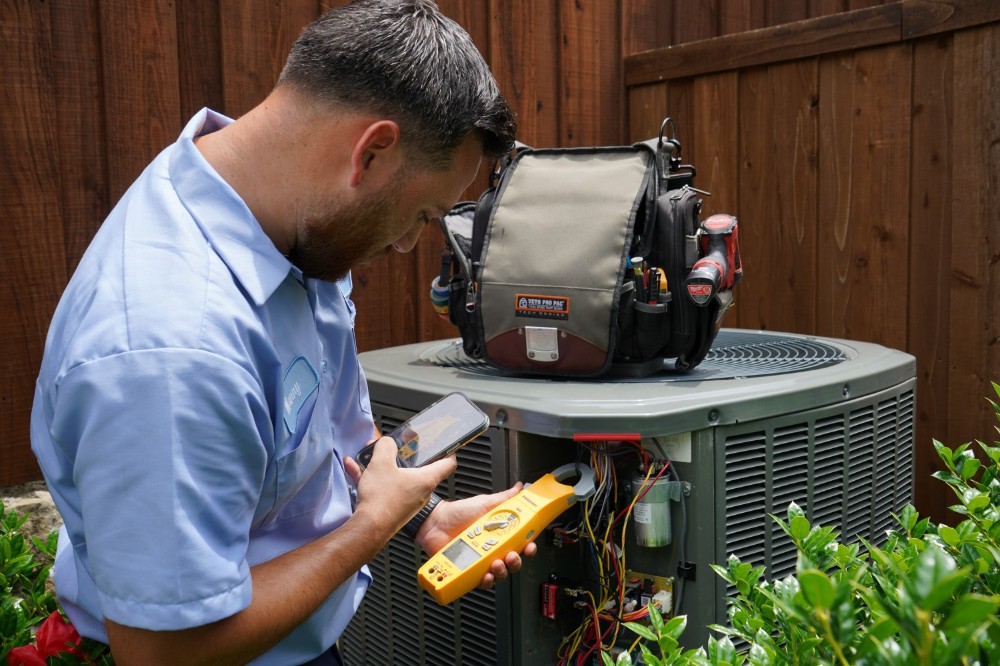 Aire Serv tech working on an outside unit