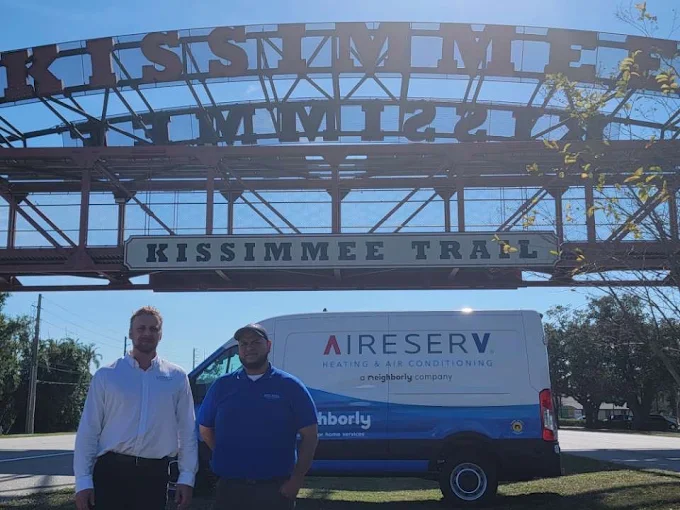 Two employees with van under the Kissimmee Trail Bridge