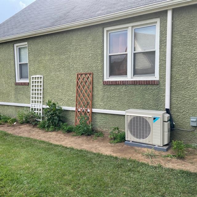 Ductless mini-split exchanger installed outside a home
