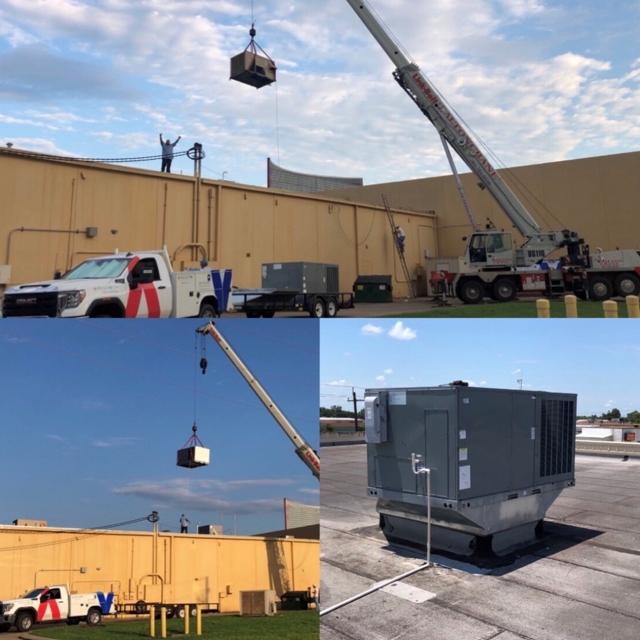 Aire Serv of Victoria truck and crane lifting a commercial rooftop HVAC unit onto a building