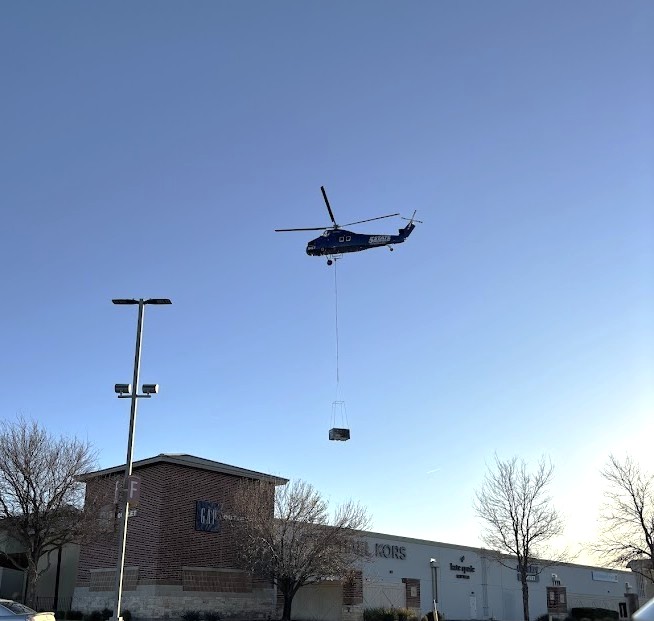 Helicopter Delivering an HVAC System to a Rooftop