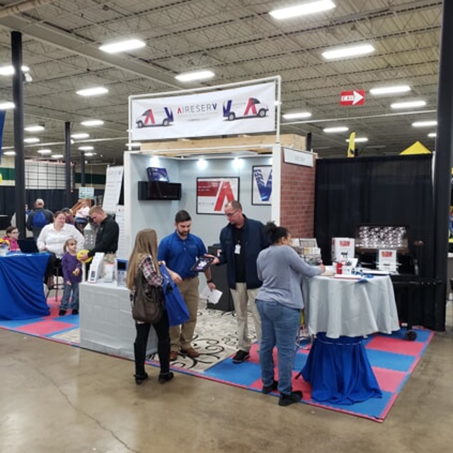 Zoomed-out view of a home show event with Aire Serv of Knoxville logos visible