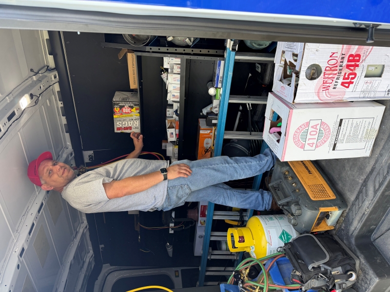 Technician Grabbing Supplies From Inside Van