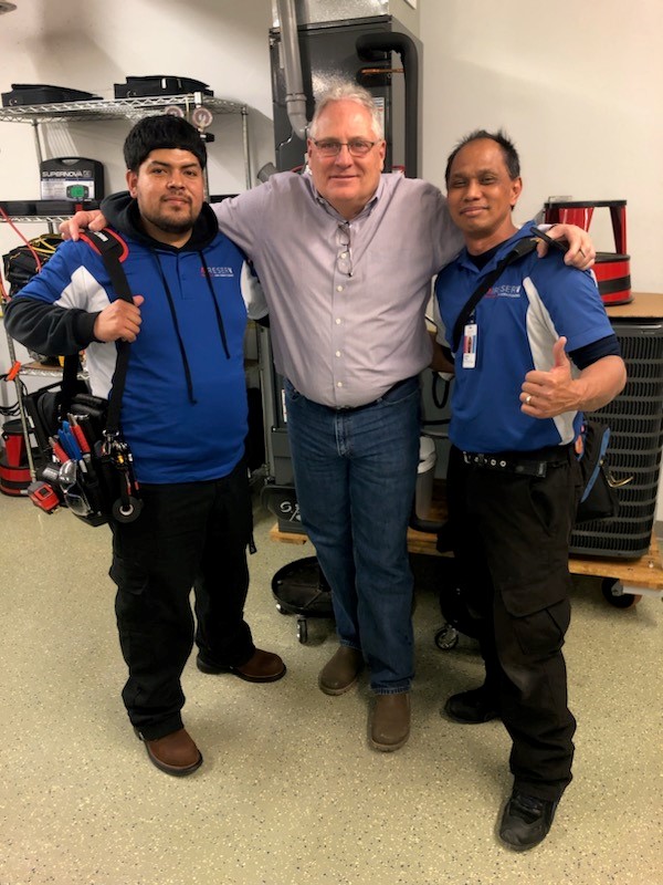 Aire Serv of Front Range service technician training session with two techs and a trainer.