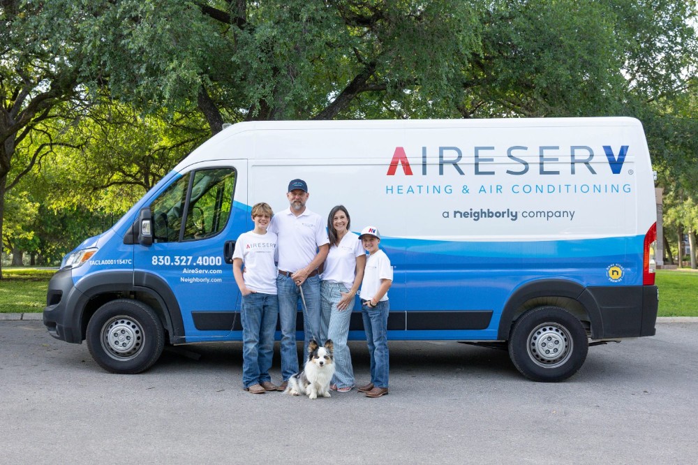 Aire serv family in front of the Aire Serv Van