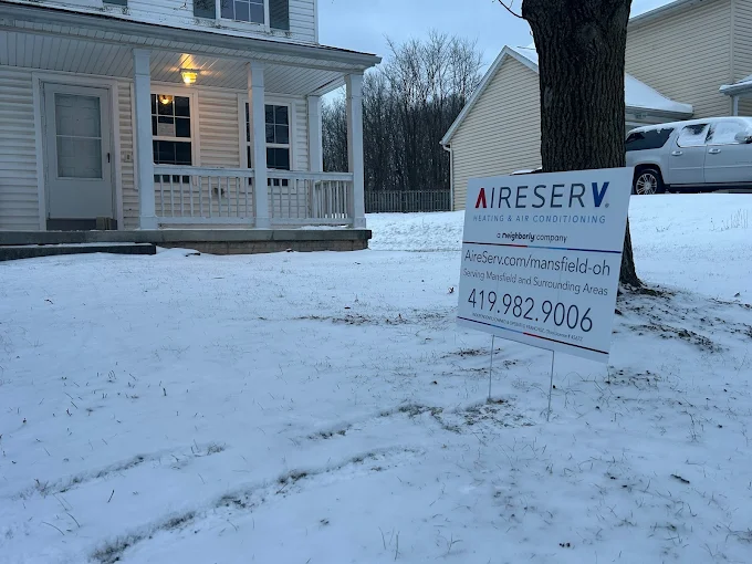 Aire Serv Signage Outside Snow Covered Home