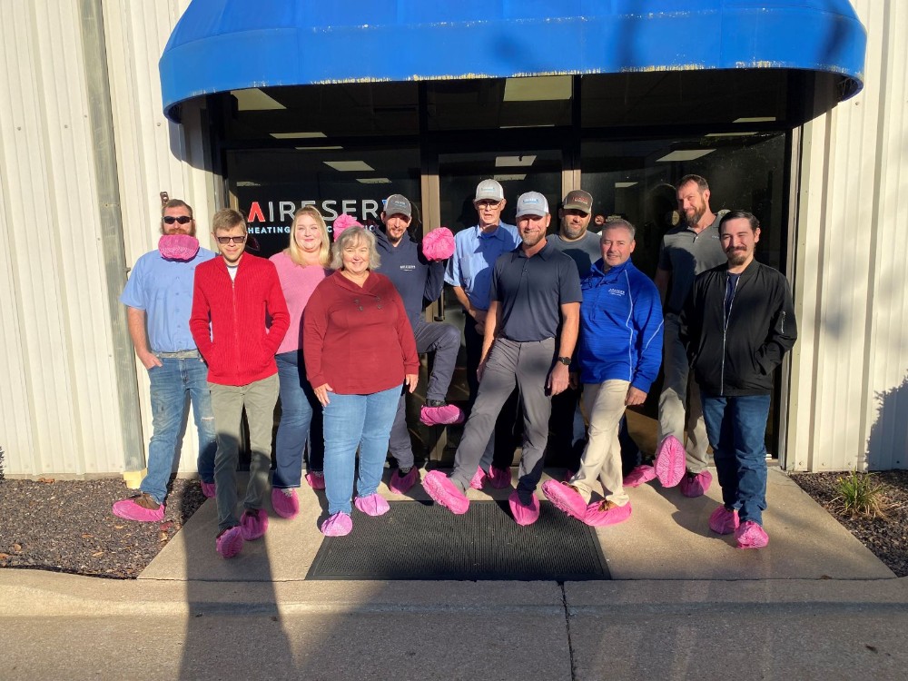 Our whole team wearing pink booties to support Breast Cancer Awareness Month