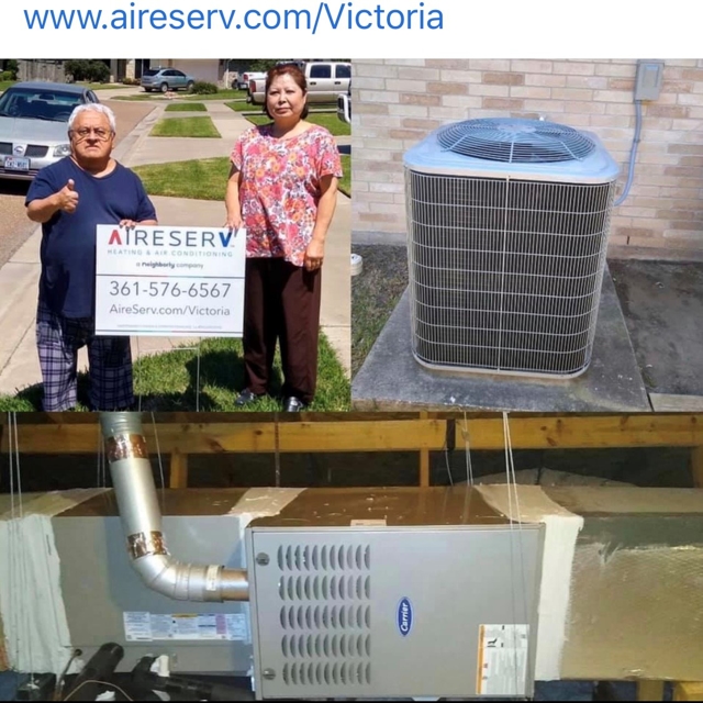 Happy couple standing next to an Aire Serv of Victoria yard sign showing their newly installed furnace and AC unit