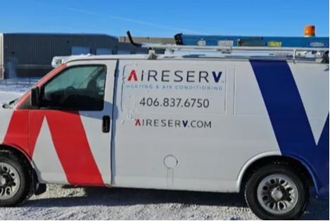 A branded Aire Serv of Kalispell HVAC service truck parked outdoors in a snowy setting.