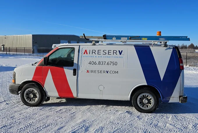 Aire Serv service van parked outside in the snow.