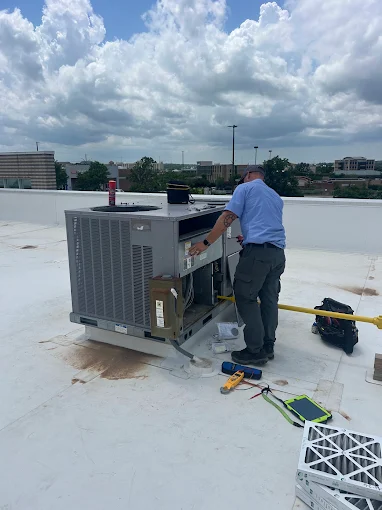 Technician Working on Rooftop Commerical Unit