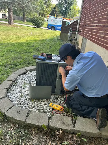 Technician Running Diagnostic Check on Outdoor AC Unit