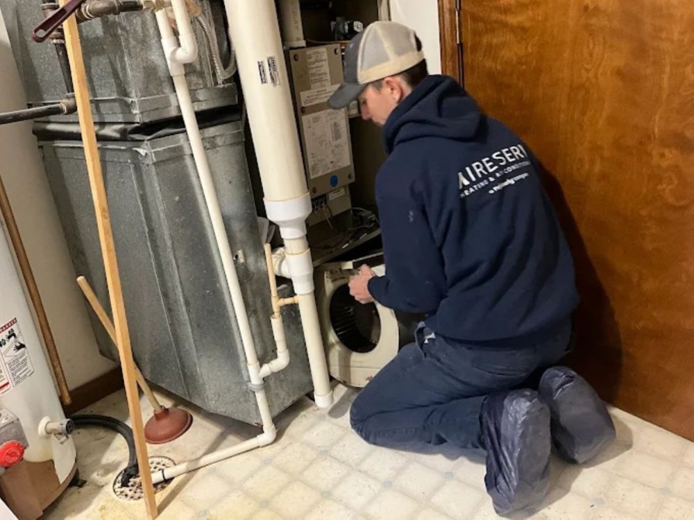 Technician In the Middle Of Servicing A Heater