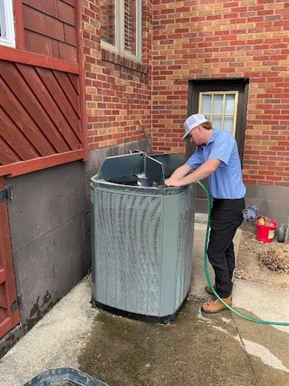 Technician Washing The Inside Of A Outside System