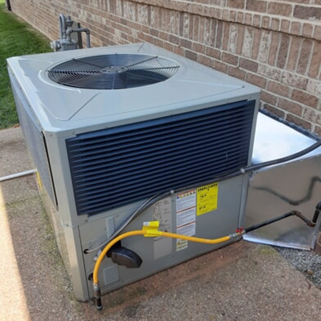 Close-up of an HVAC unit installed outside a residential home