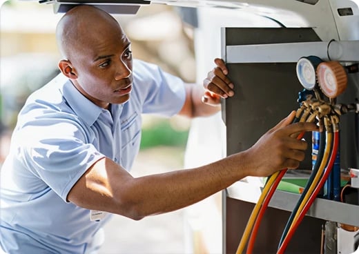 Aire Serv technician grabbing manifold gauge from back of van.