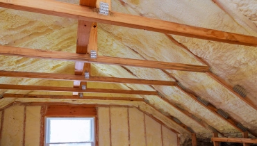 An unfinished attic space with insulation fitted throughout the walls and ceiling. | Aire Serve of North Central Arizona