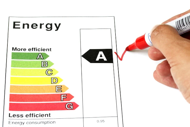 Person checking off A on Energy efficient sheet with red pen