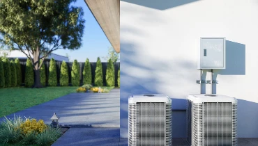 Two outdoor components of an air conditioning unit are seen outside of a home. | Harris Aire Serv