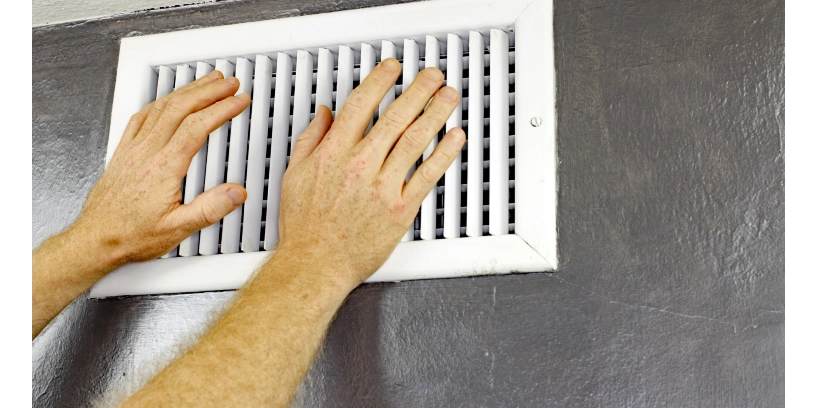 Person feeling for air coming out of an air duct