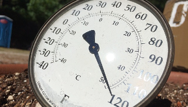 Thermometer on the ground showing 120 degrees
