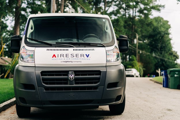 Aire Serv HVAC van parked on a residential street.