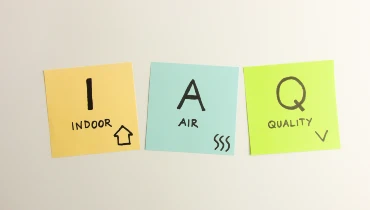 Indoor air quality's acronym IAQ handwritten on sticky notes.