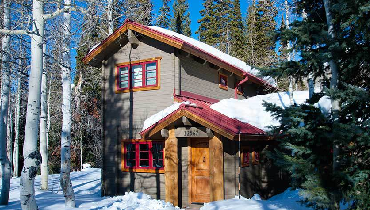 Winter cabin covered with snow