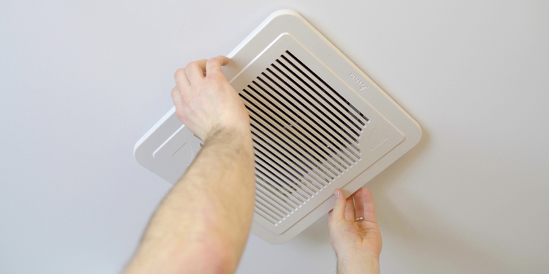 Hands removing air vent