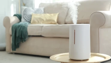 A portable air humidifier on table in modern living room.