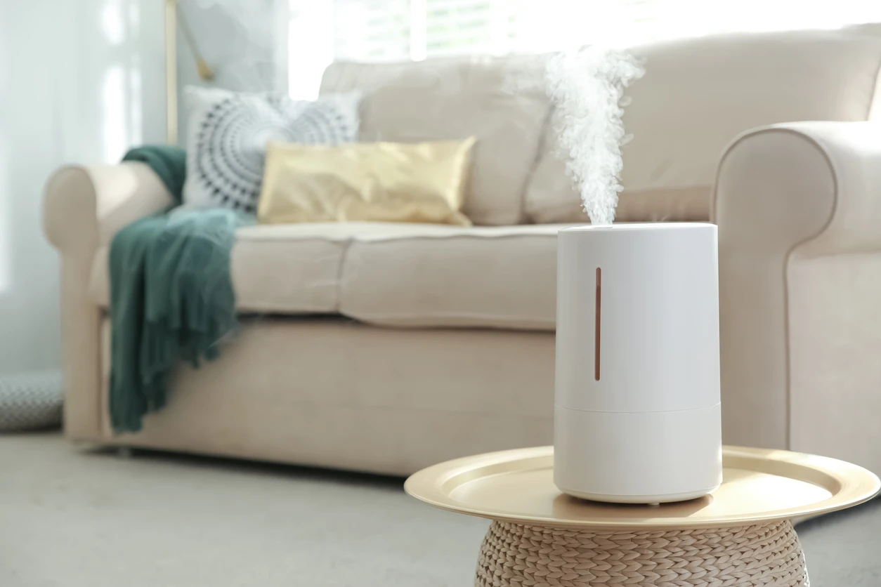 A portable air humidifier on table in modern living room.