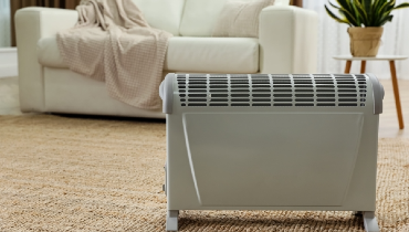 Modern electric convection heater on living floor of a residential home