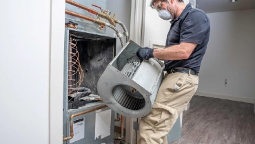 HVAC technician repairing a blower motor on a residential HVAC system