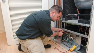 Service technician working on a residential AC unit