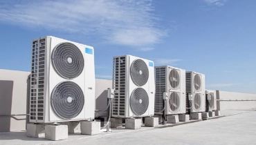 Large air conditioning condensers on the roof of an industrial building. | Aire Serv of Western North Carolina