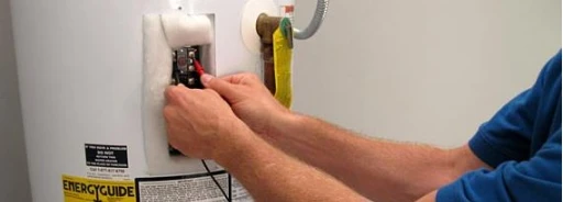 Tech servicing a water heater
