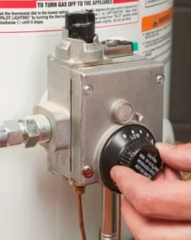 Person setting water heater temperature