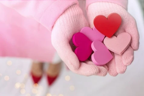 Girl holding hearts in hands