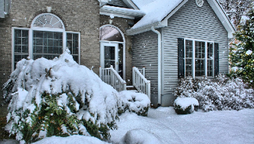 House during a snow storm with snow on the ground