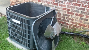 Residential AC unit with cover off for cleaning and maintenance.